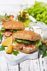 sandwich with salted fish and cream cheese on wooden board, vertical