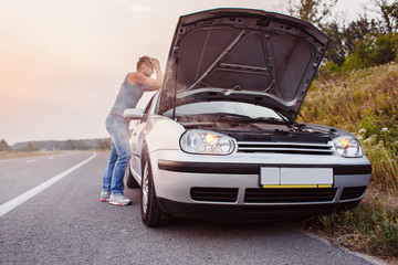 The car broke down, smokes from under the hood, the driver shocked