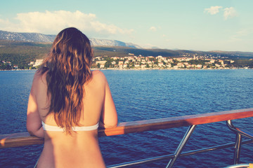 Woman on a yacht looking at the shore in Croatia