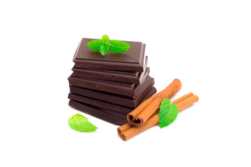 Stack of dark chocolate pieces isolated on white