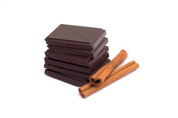 Stack of dark chocolate pieces isolated on white