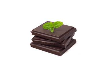 Stack of dark chocolate pieces isolated on white