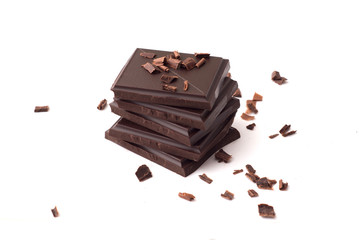 Stack of dark chocolate pieces isolated on white