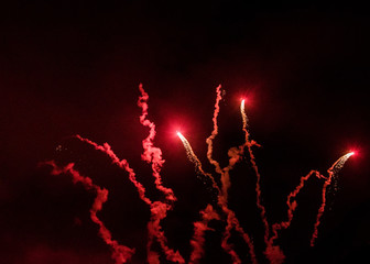 Red firework in night sky