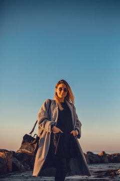Portrait of woman wearing sunglasses and winter coat looking at camera smiling, Odessa, Odeska Oblast, Ukraine, Eastern Europe