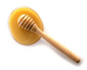 Honey with wooden honey dipper on white background