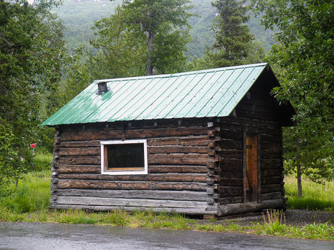 old rustic log cabin in Alaska wilderness