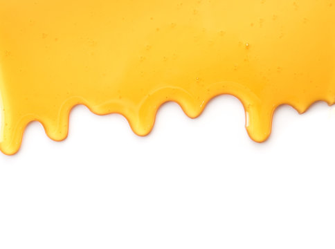Naklejki Dripping honey isolated on white background