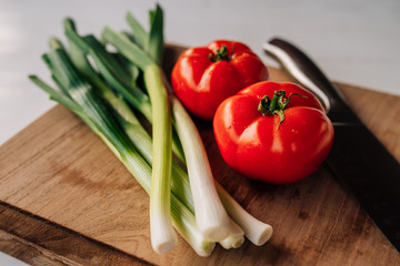 Close-up image of tomatoes and spring onion.