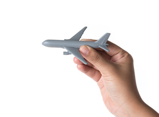 Hand holding miniature airplane isolated on white background