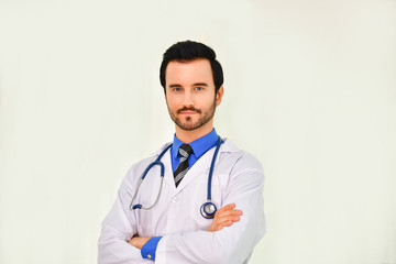 Fototapeta premium Smiling doctor posing in the office, he is wearing a stethoscope, medical staff on the hospital background