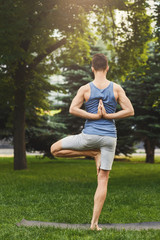 Young man practicing yoga, Reverse Prayer Pose