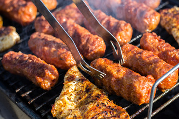 Close up pf delicious chicken breast on wooden skew with fresh vegetables, garlic, paprika fried on mangal barbeque grill