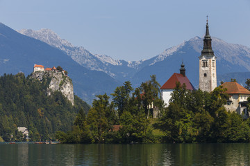 Fototapeta na wymiar Church on Island in Lake Bled, Slovenia, with Castle in distance