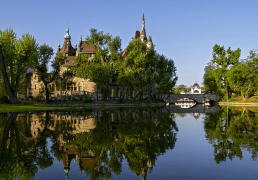 Beautiful castle Vajdahunyad is reflected in the lake. Varosligetsky park at  summer. Cultural heritage. Travel . Budapest, Hungary.