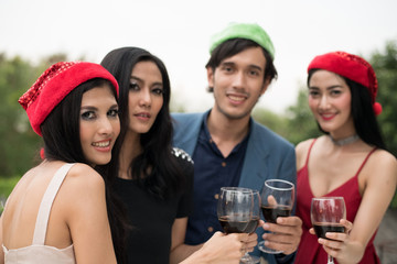 Young people holding glass talk in the party.