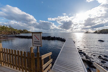wooden jetty with a sign diving forbidden in swedish
