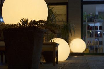 Round street lights in front of the cafe.