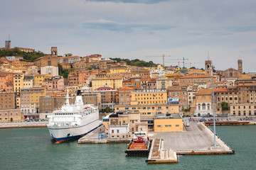 Cityscape of Ancona with ferries at the port viewed from the sea
