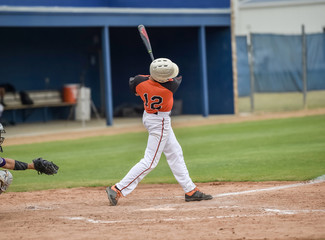 Baseball player swinging at the ball