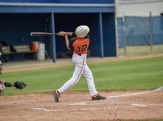 Baseball player swinging at the ball