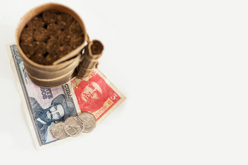 Blurred Cuban cigars rolled in banana leaf and cuban pesos with heroes icon of Guevara and...
