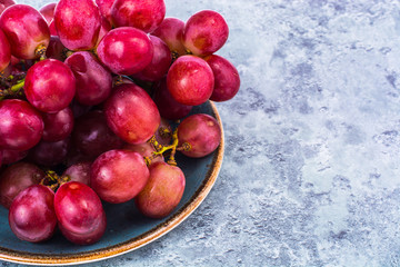Plate with sweet, ripe red grapes
