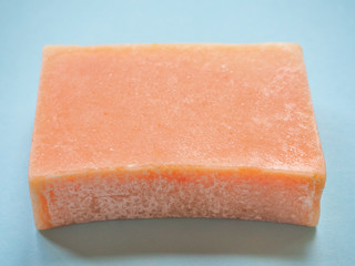 Soap economic on a wooden background. One piece handmade soap.