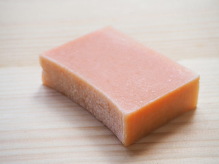Soap economic on a wooden background. One piece handmade soap.