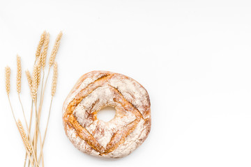 Home bread with classic recipe. Round loaf on white background top view copy space
