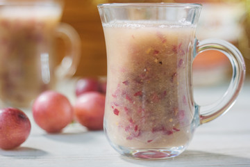 Grape smoothie over the white table.