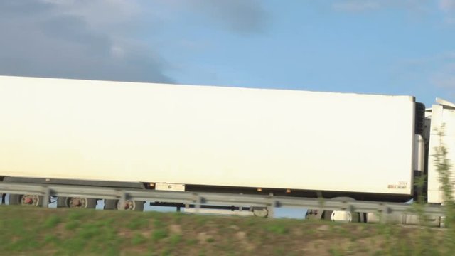 Cargo truck travel on inter city highways. International cargo transportation. Truck car drives through the bridge.