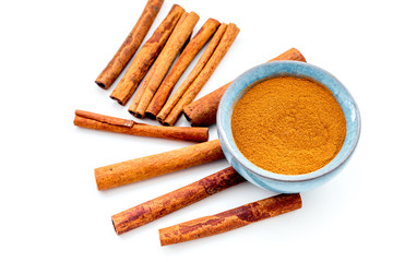 Cinnamon seasoning. Sticks and powder on white background top view