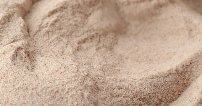 A very close video of using a spoon to stir orange flavor psyllium husks then take a spoonful at the end.