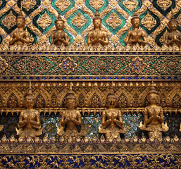 Golden Buddha statues, detail of the Wat Phra Kaew, Grand Palace, Bangkok (Krung Thep), Thailand, Asia. Traditional patterns wallpaper and background. Royal Palace Bangkok closeup.