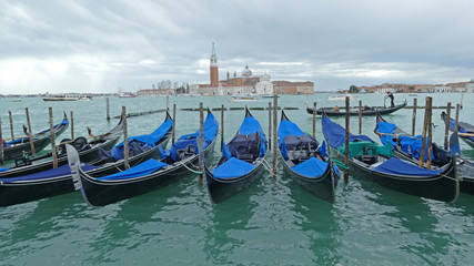 Fototapeta na wymiar Gondolas parked at San Marco square, Venice, Italy
