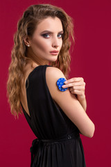 Pretty long hair woman holding chips for gambling. Studio shot