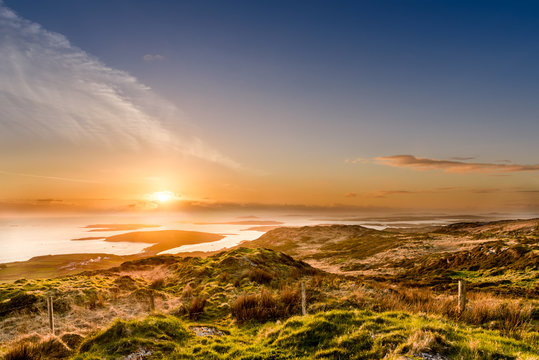 Lovely sunset at the west part of Ireland with some lonely islands in the background; photographed from the hill top