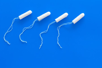 Woman hygiene protection. Cotton tampons on blue background top view copy space