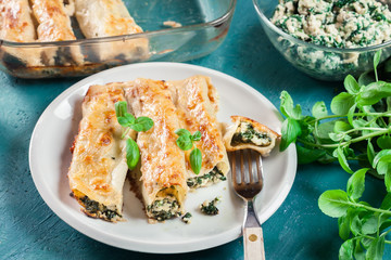 Portion of cannelloni stuffed with spinach