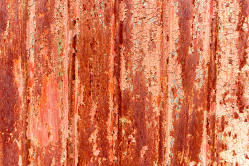 Red, rusty background with peeling paint.