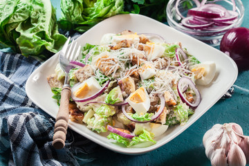 Healthy caesar salad with cheese, eggs and croutons