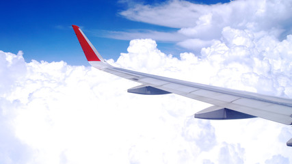 KUALA LUMPUR, MALAYSIA - APR 4th 2015: View of the clouds and airplane wing from inside an plane, window seat