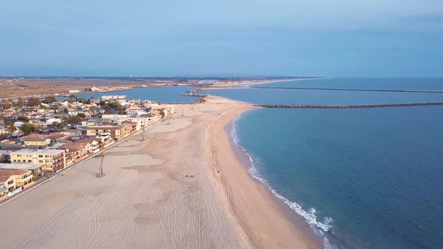 Drone dolly in beach harbor jetty aerial ocean