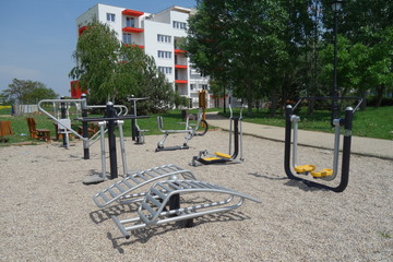 Concept of modern housing. Outdoor sports ground with Various Training Apparatus  in front of Modern, new residential house. Slovakia, town of Vrable.