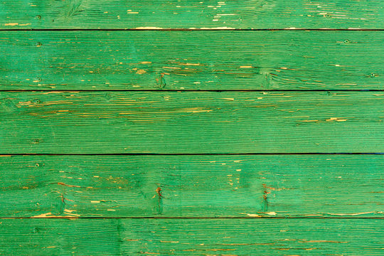 Amazingly beautiful old texture of a green wooden wall with cracked paint