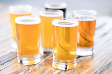 Side view on a flight of craft beer in pint glasses