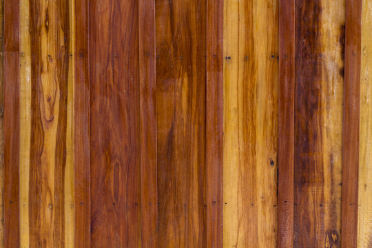 Polished wooden surface texture. Warm brown timber texture macro photo. © Elya.Q