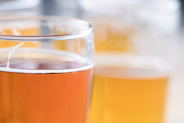 Macro close up on a pint of craft beer with suds on the surface