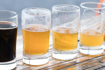 Row of pint glasses with decreasing volumes of of beer